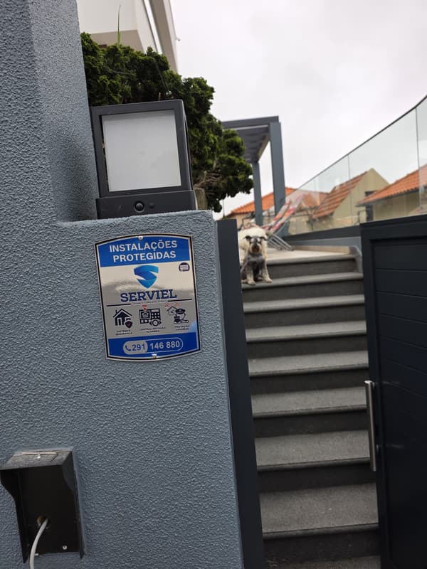 Sistema de alarme instalado pela Serviel Madeira numa moradia, com placa de sinalização à entrada